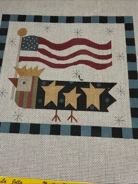 needlepoint canvas features a stylized bird American flag banner and stars.🐈‍⬛